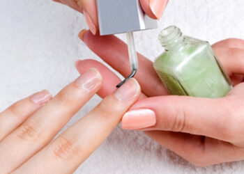 applying manicure: moisturizing the nails and skin around nails