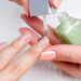 applying manicure: moisturizing the nails and skin around nails