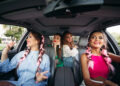 Trendy, stylish, trendy girlfriends go in the car listening to music and having fun together. They go shopping for their city. Friends rest together and shopping is always together.